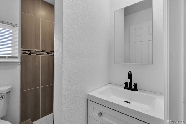 bathroom with vanity and toilet