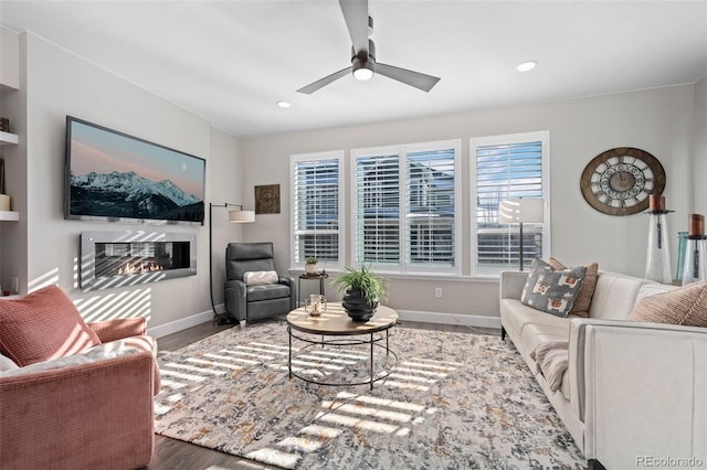 living room featuring wood-type flooring and ceiling fan