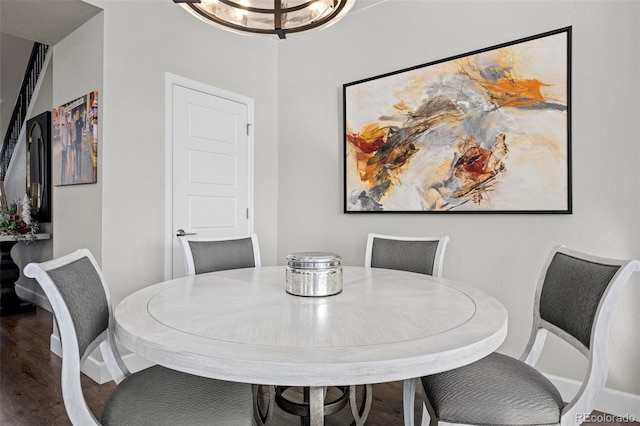 dining area featuring hardwood / wood-style floors and an inviting chandelier