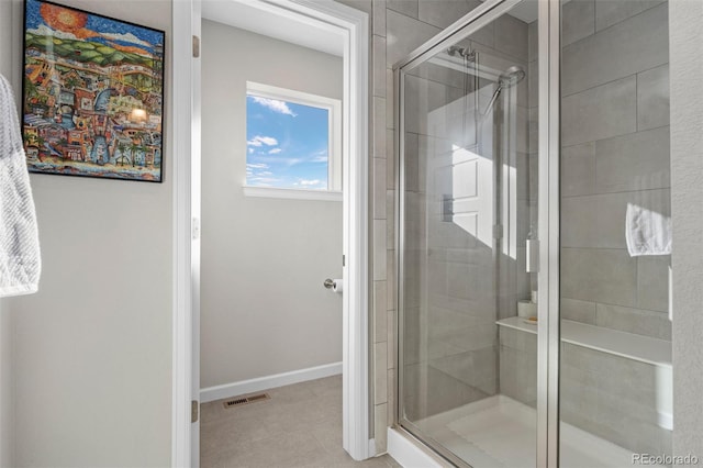 bathroom with a shower with door