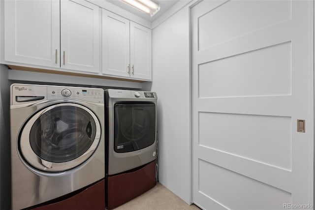 clothes washing area with cabinets and independent washer and dryer