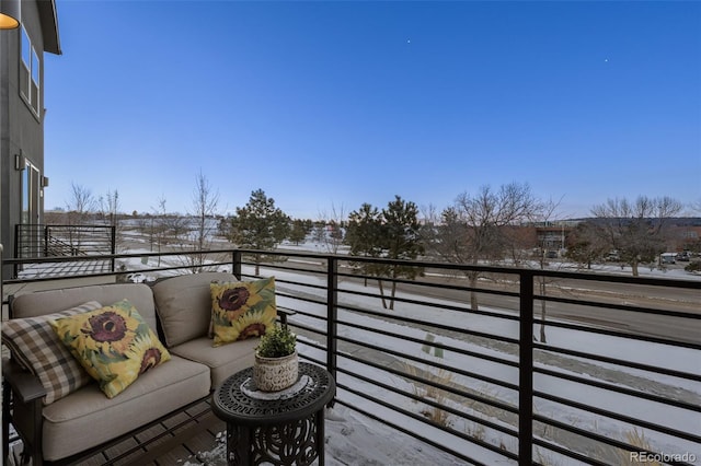 view of snow covered back of property