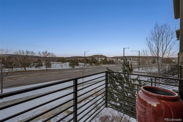 view of snow covered back of property