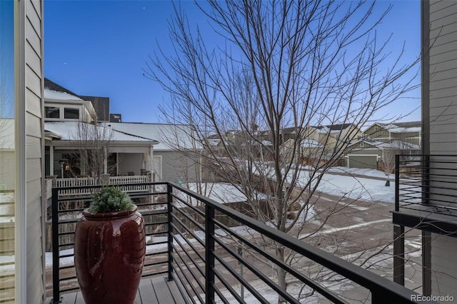 view of snow covered back of property