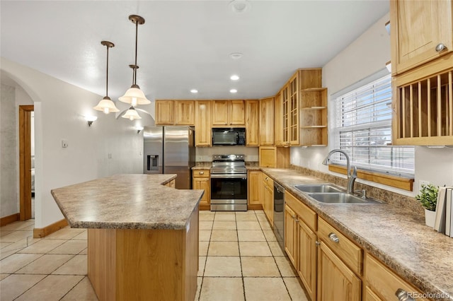 205 Beech St, Hudson, CO 80642 - kitchen featuring appliances with stainless steel finishes, light tile patterned floors, a center island, arched walkways, and glass insert cabinets