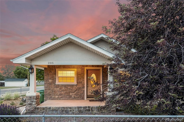205 Beech St, Hudson, CO 80642 - view of front of home featuring stone siding and covered porch