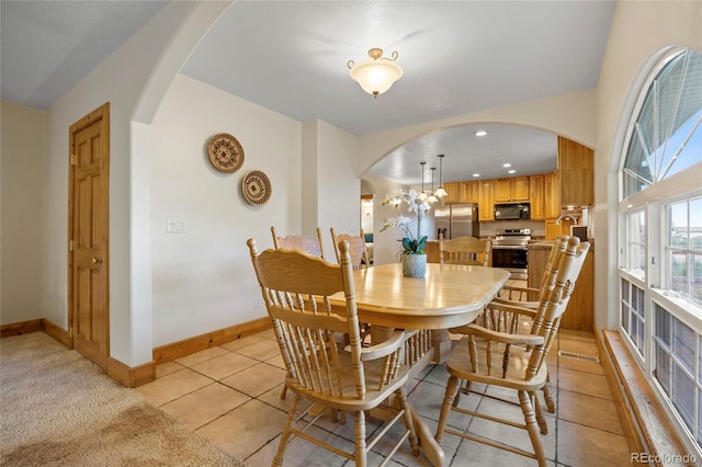 205 Beech St, Hudson, CO 80642 - dining area with arched walkways and light tile patterned floors