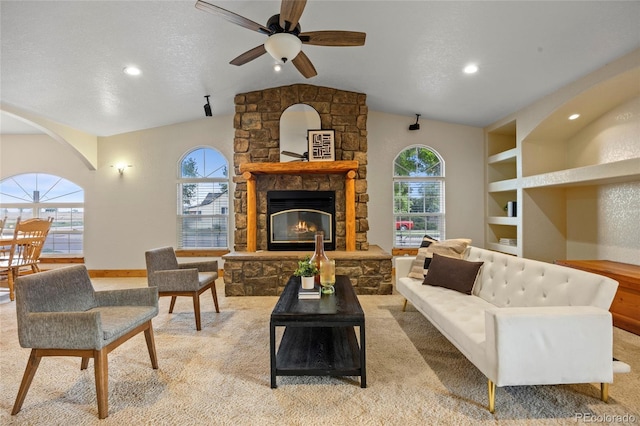 205 Beech St, Hudson, CO 80642 - living room featuring vaulted ceiling, a ceiling fan, a stone fireplace, light colored carpet, and recessed lighting