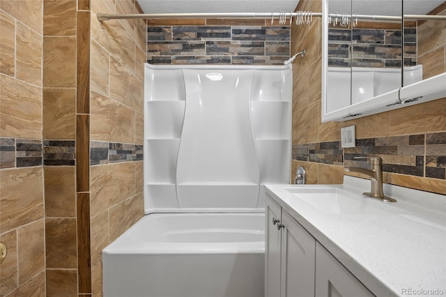 205 Beech St, Hudson, CO 80642 - bathroom featuring tile walls, vanity, shower / bath combination, and decorative backsplash