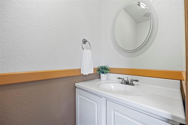 205 Beech St, Hudson, CO 80642 - bathroom featuring a textured wall and vanity