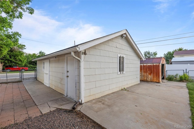 205 Beech St, Hudson, CO 80642 - garage with a storage unit and a gate
