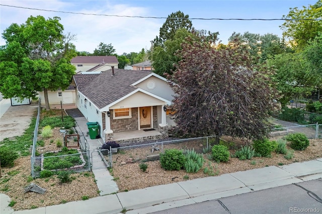 205 Beech St, Hudson, CO 80642 - view of front of house with a porch, a gate, a fenced front yard, stone siding, and stucco siding