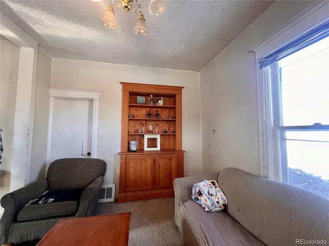 carpeted living room with a textured ceiling