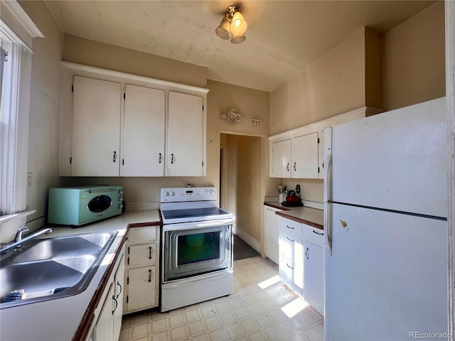 kitchen with white cabinetry, white appliances, and sink