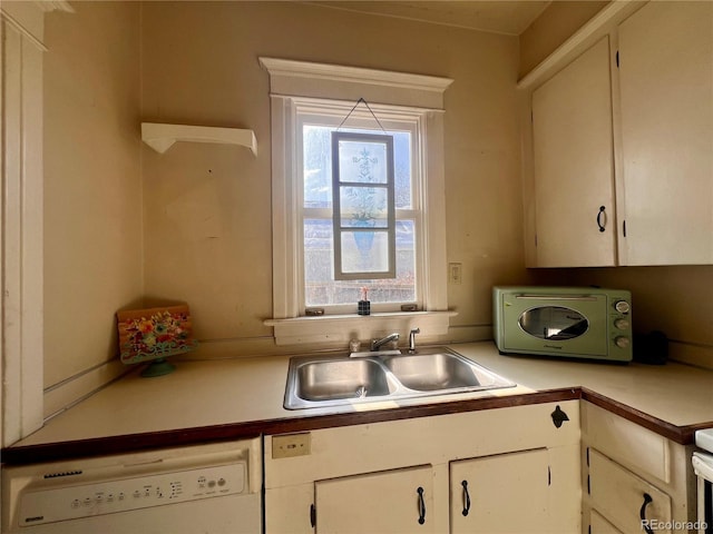 kitchen featuring sink, white cabinets, and dishwasher