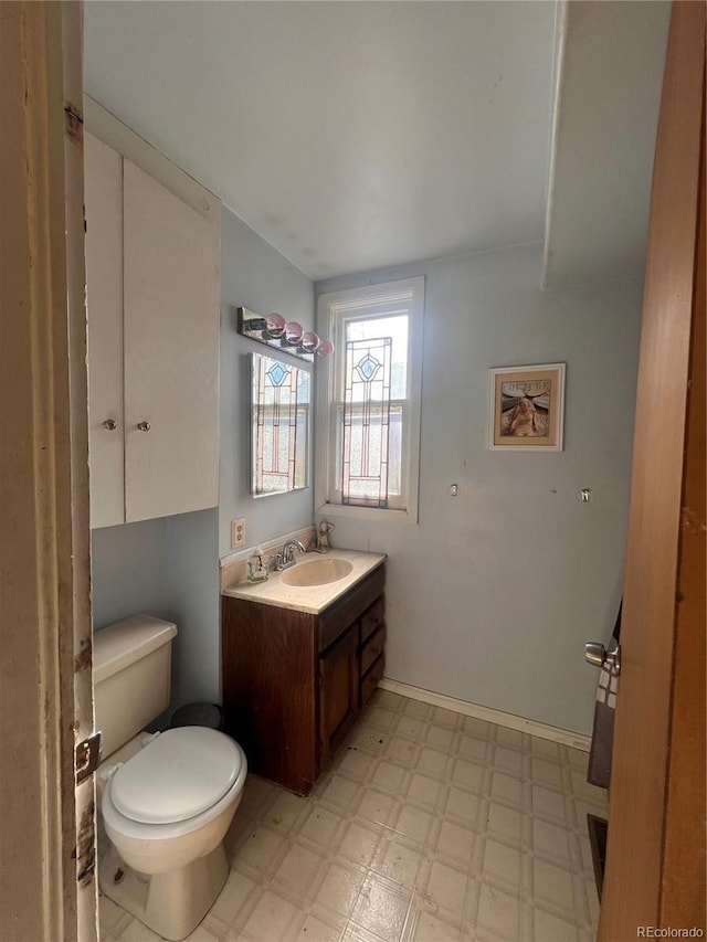 bathroom featuring vanity and toilet