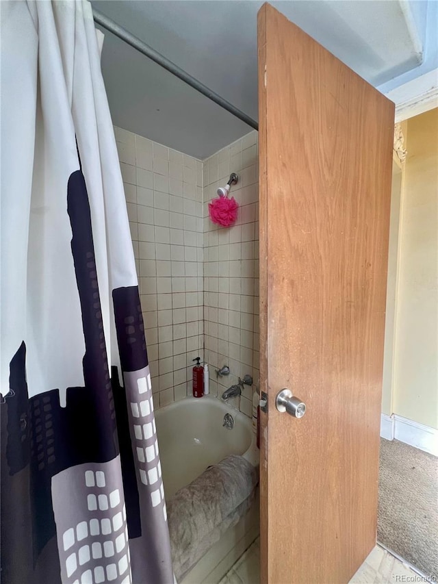 bathroom with shower / tub combo with curtain