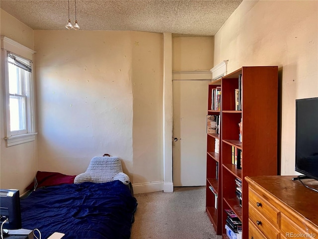 carpeted bedroom with a textured ceiling