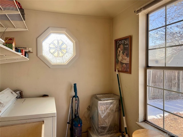 laundry room featuring a wealth of natural light and washer and clothes dryer