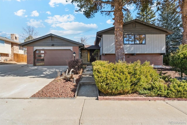 tri-level home with brick siding, driveway, and an attached garage