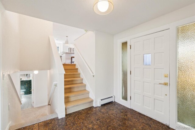 foyer with a baseboard radiator and stairs