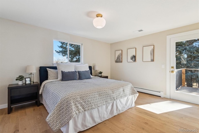 bedroom featuring visible vents, baseboard heating, light wood-style flooring, and access to exterior