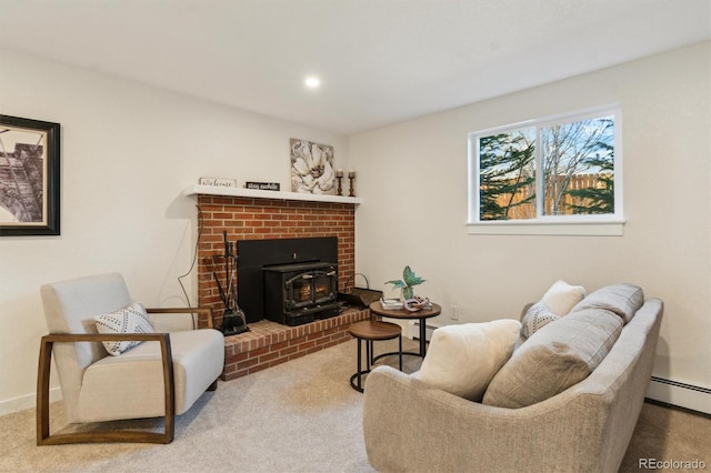 living room with a wood stove, carpet, a baseboard heating unit, and baseboards