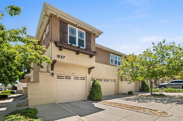 837 E 98th Ave Unit 405, Thornton, CO 80229 - multi unit property featuring a garage, driveway, and stucco siding