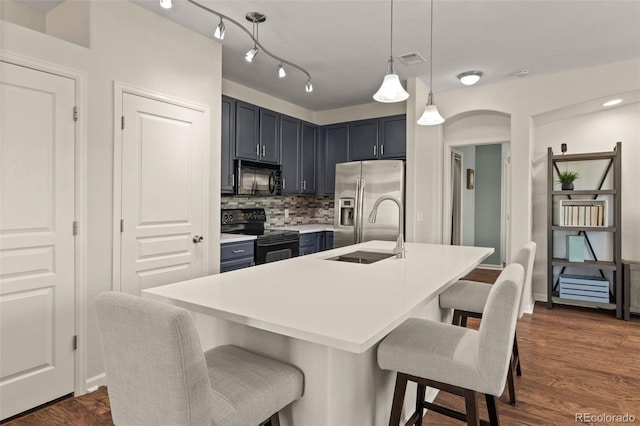 837 E 98th Ave Unit 405, Thornton, CO 80229 - kitchen with black appliances, a kitchen bar, backsplash, light countertops, and decorative light fixtures