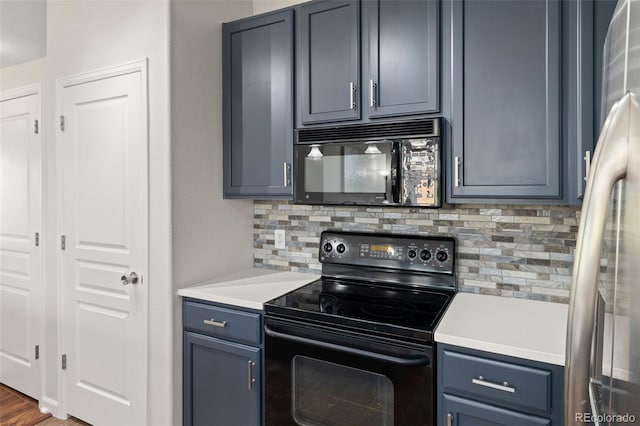 837 E 98th Ave Unit 405, Thornton, CO 80229 - kitchen featuring black appliances, backsplash, light countertops, and blue cabinets