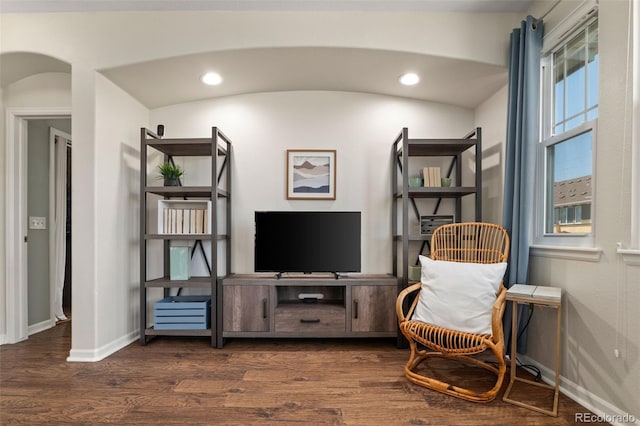 837 E 98th Ave Unit 405, Thornton, CO 80229 - living area featuring dark wood finished floors, arched walkways, and recessed lighting