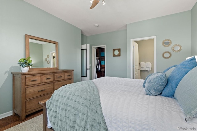 837 E 98th Ave Unit 405, Thornton, CO 80229 - bedroom with wood finished floors, a spacious closet, ensuite bath, and a ceiling fan