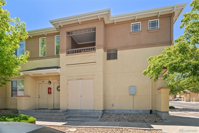 837 E 98th Ave Unit 405, Thornton, CO 80229 - townhome / multi-family property featuring stucco siding, entry steps, and a balcony
