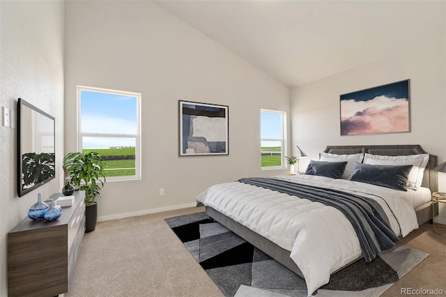 bedroom featuring multiple windows, light carpet, and high vaulted ceiling