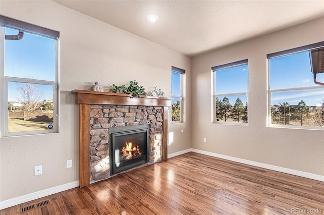 unfurnished living room with a fireplace and wood-type flooring