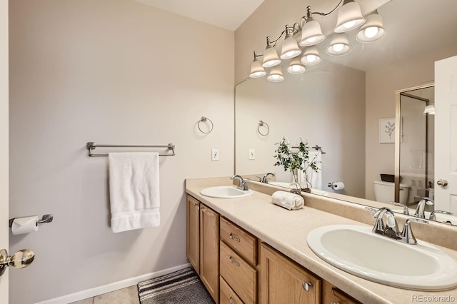 bathroom featuring toilet, vanity, tile patterned floors, and a shower with door