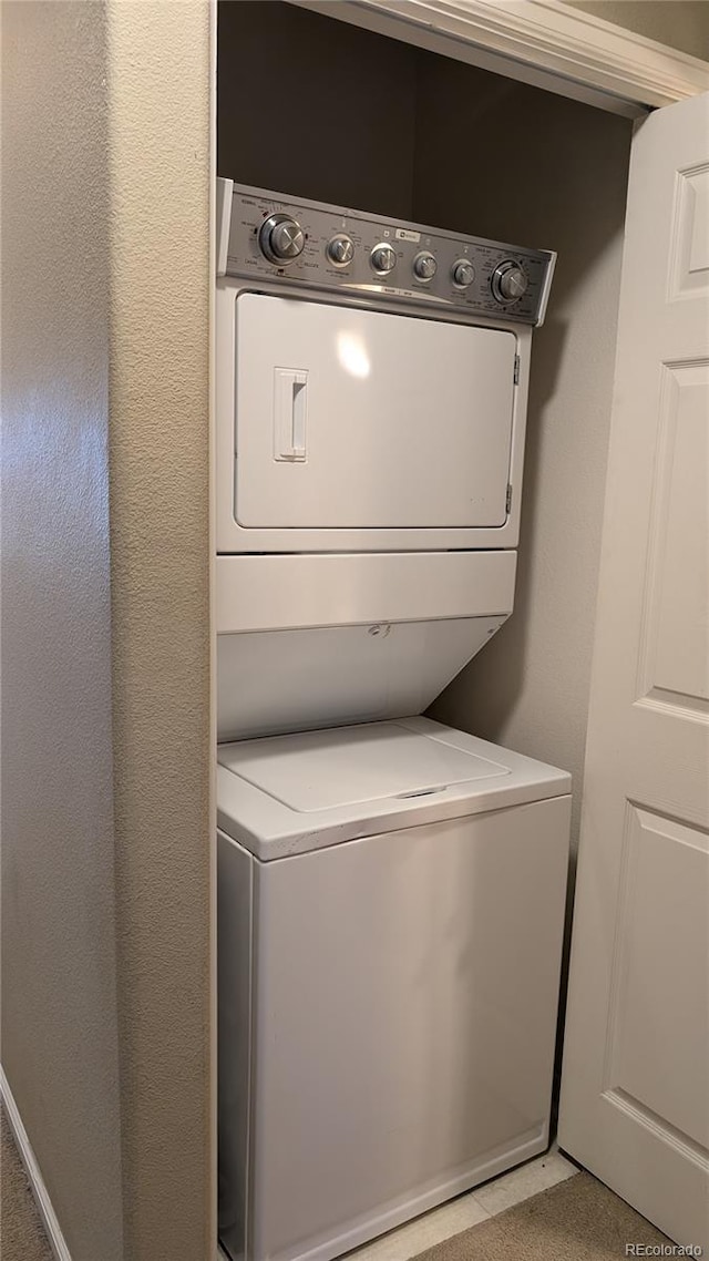 washroom with stacked washer / drying machine