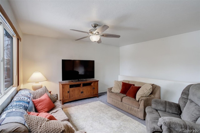 living room featuring ceiling fan and light colored carpet