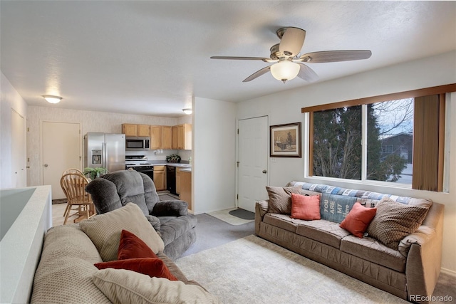 carpeted living room featuring ceiling fan