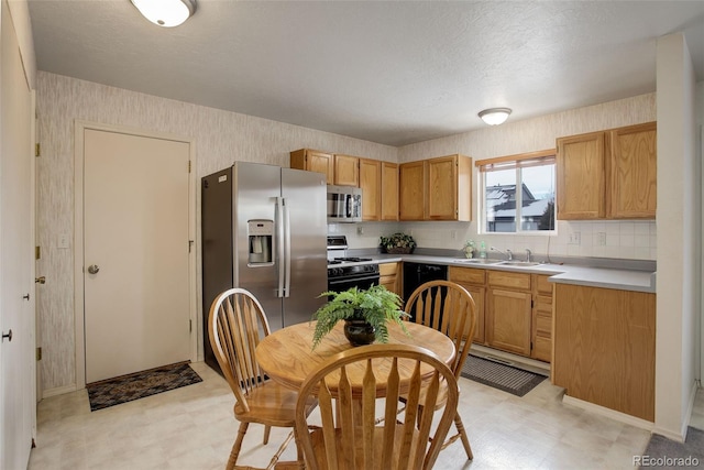 kitchen featuring sink, decorative backsplash, and appliances with stainless steel finishes