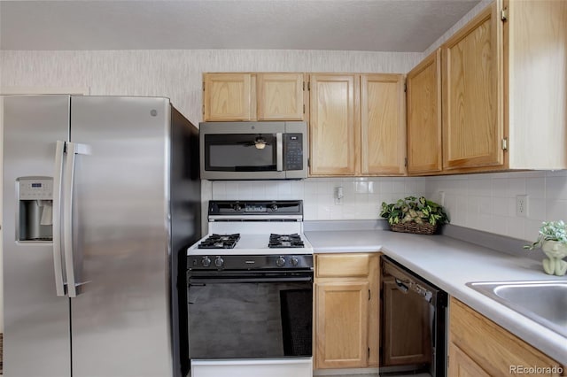 kitchen with sink, light brown cabinetry, appliances with stainless steel finishes, and decorative backsplash