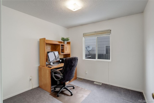 office area featuring a textured ceiling and carpet floors