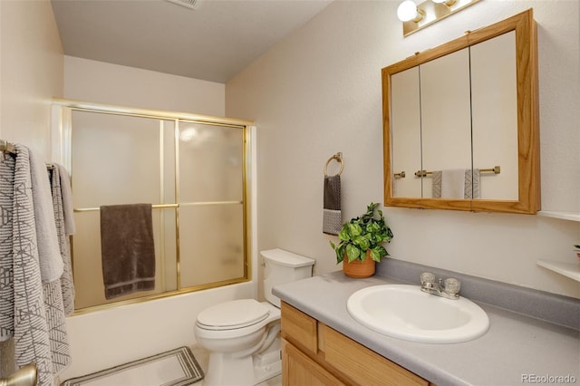 full bathroom featuring vanity, toilet, and enclosed tub / shower combo