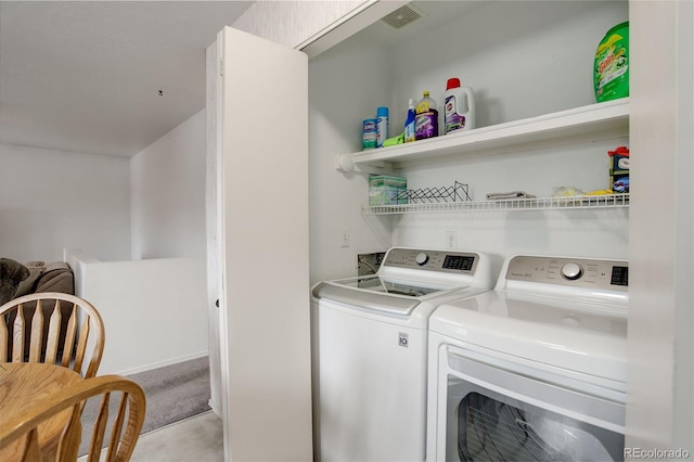 washroom with light colored carpet and washing machine and clothes dryer