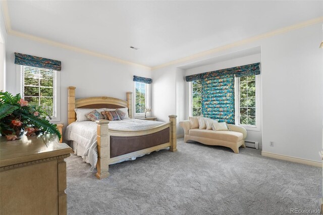 carpeted bedroom featuring crown molding, a baseboard heating unit, and multiple windows