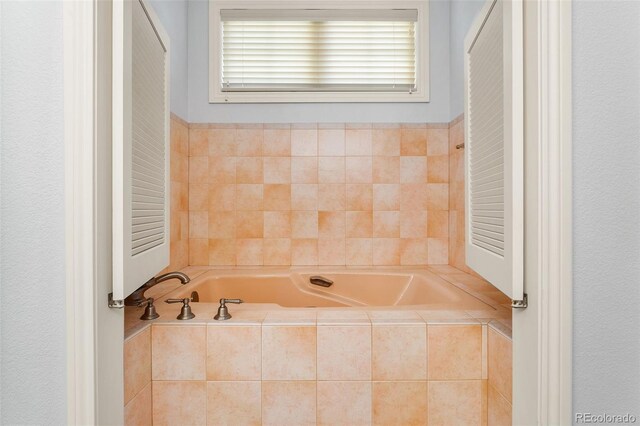 bathroom featuring tiled tub