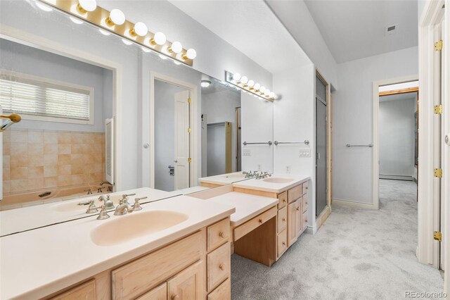 bathroom featuring a washtub and vanity