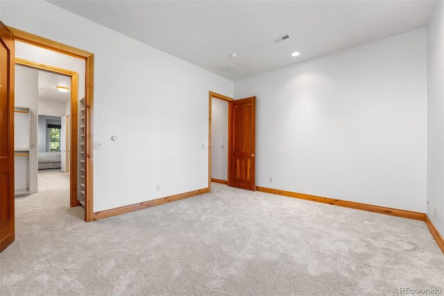 unfurnished room featuring light colored carpet