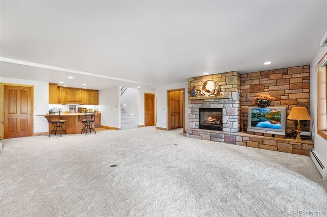 unfurnished living room featuring light carpet and a stone fireplace