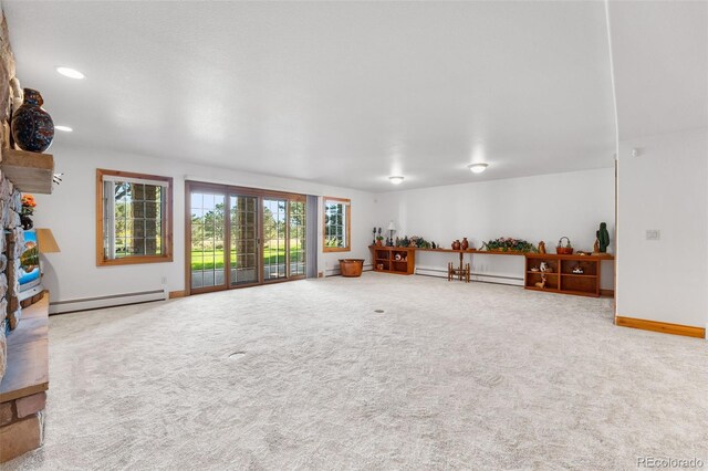 living room featuring baseboard heating and carpet